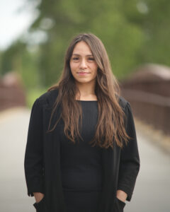 Chenoa Sandoval standing outdoors, founder of Earth Maid in Okotoks