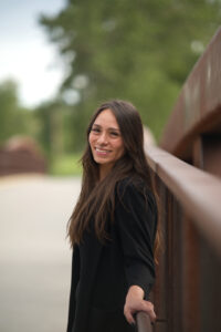 Chenoa Sandoval, founder of Earth Maid, smiling outdoors in Okotoks