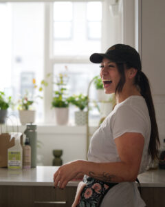 Chenoa Sandoval laughing in a kitchen while providing home cleaning service