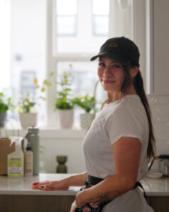 Earth Maid owner wiping a kitchen counter during a detailed home clean