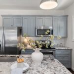Bright modern kitchen with stainless steel appliances and elegant decor.